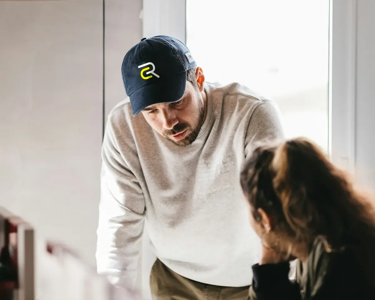 A contractor walking a homeowner through the job at her kitchen counter